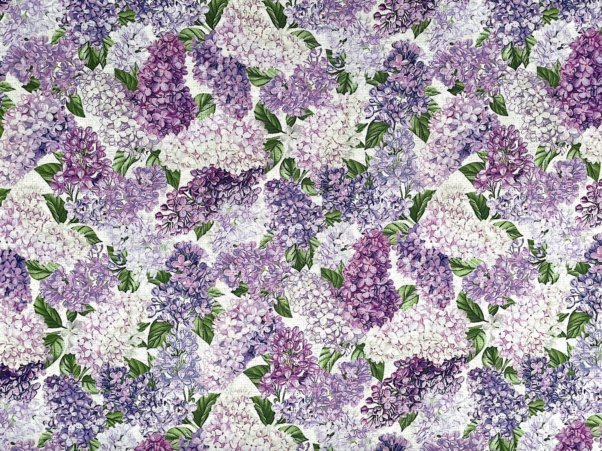 Cotton fabric covered with white, purple and lavender lilacs.