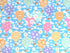 Blue cotton fabric covered with hot air balloons that are purple, pink, green.