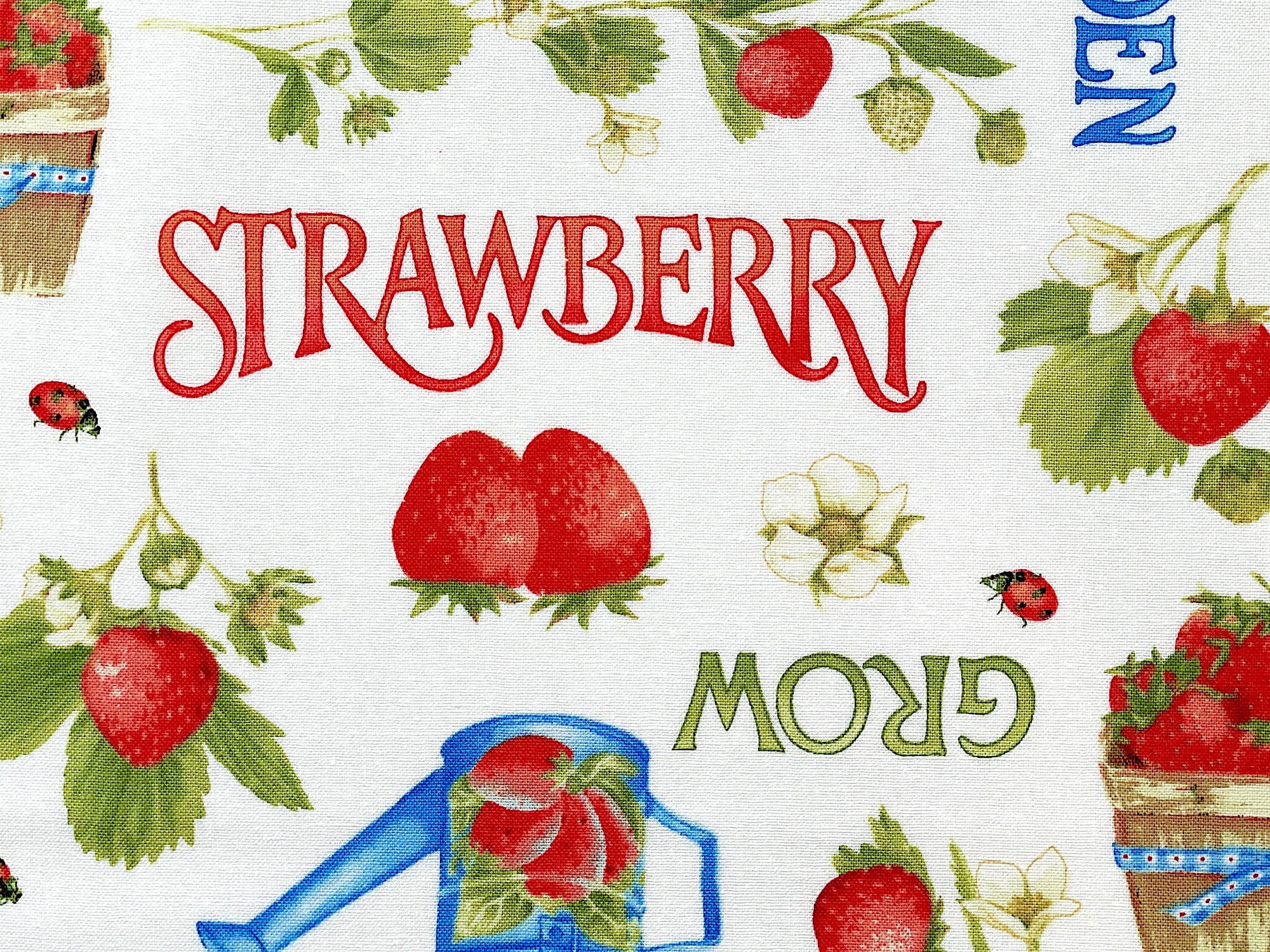 Close up of the word strawberry and some strawberries