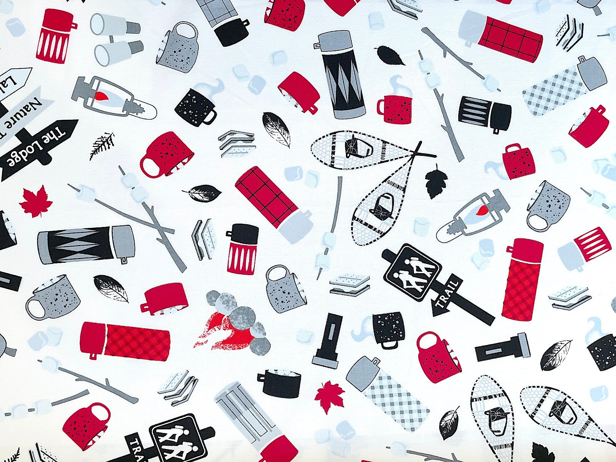 This fabric is called Camping Memories and is part of the Great Outdoors collection by Kanvas Studio. This black, white and red fabric is covered with lanterns, cups, smores, snowshoes, backpacks and more. Directional signs say trail, the lodge, nature trail and lakefront. 