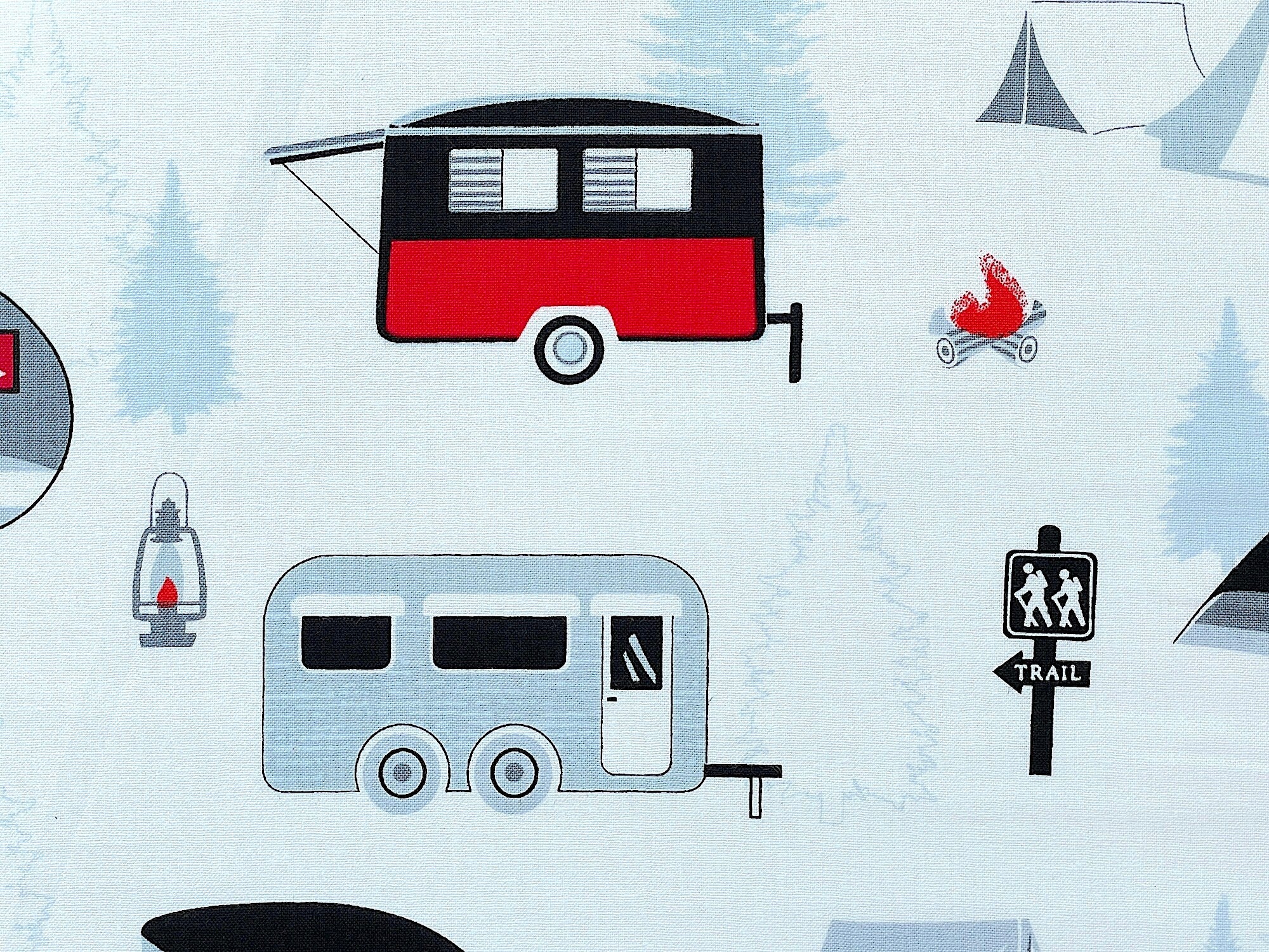 Close up of red, black and white travel trailers.