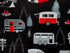 Close up of black, white and red travel trailers and trees.