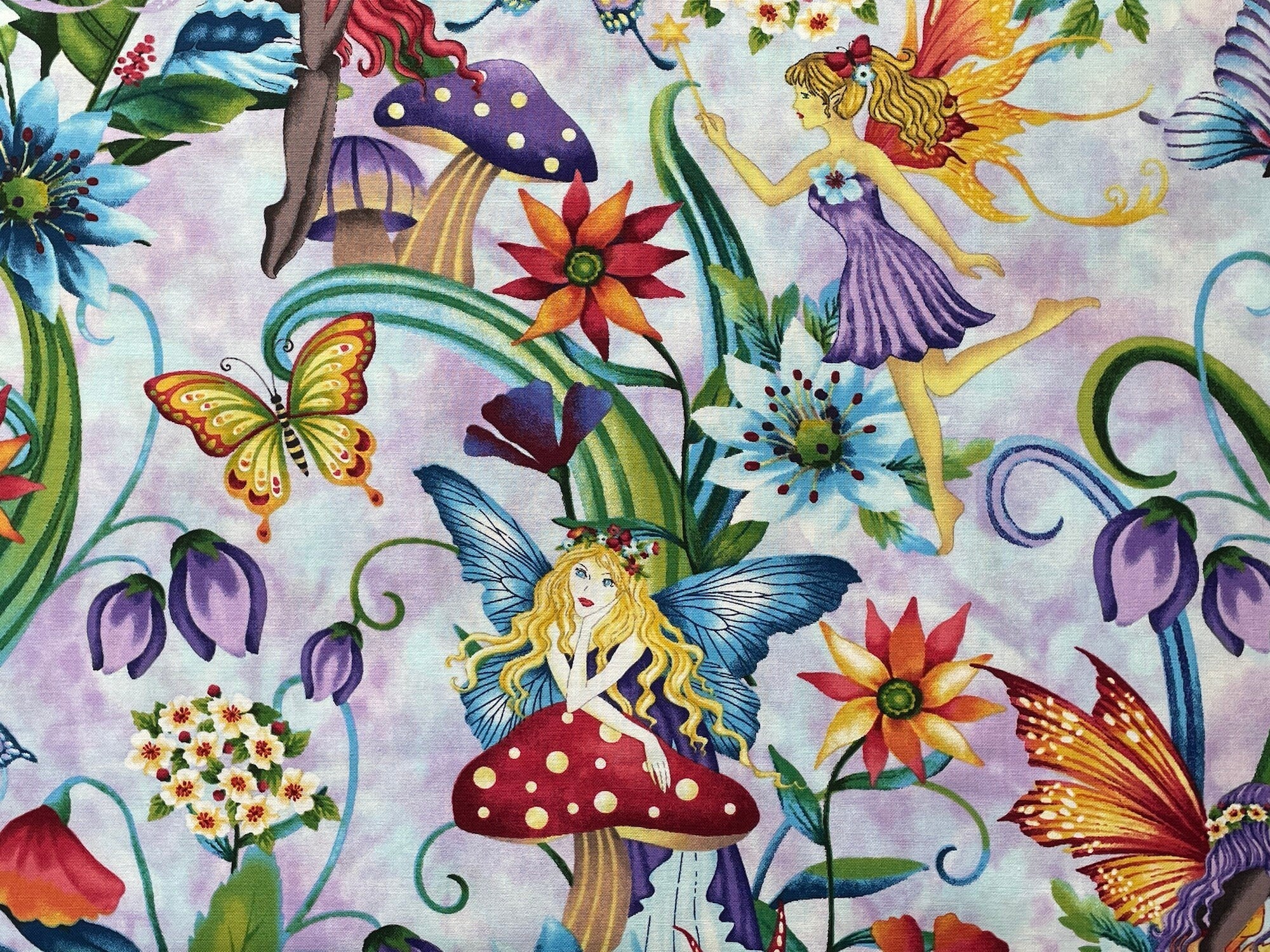 This fabric is part of the Fairytale Forest collection by Henry Glass. This lavender fabric is covered with fairies, toadstools, flowers, butterflies and more