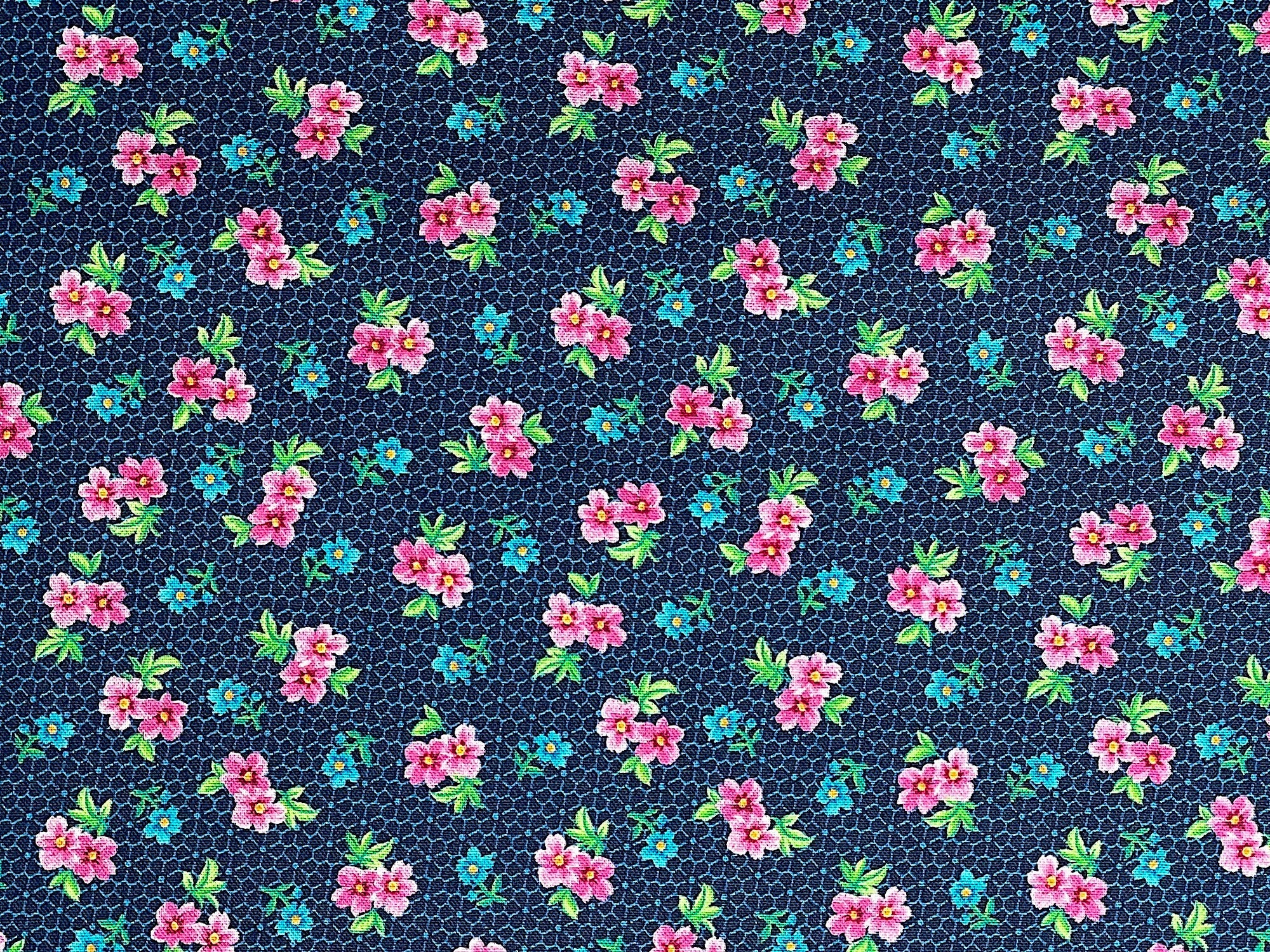 This fabric is part of the Floral Cache collection by QT fabrics. This blue fabric is covered with small red and blue flowers and green leaves