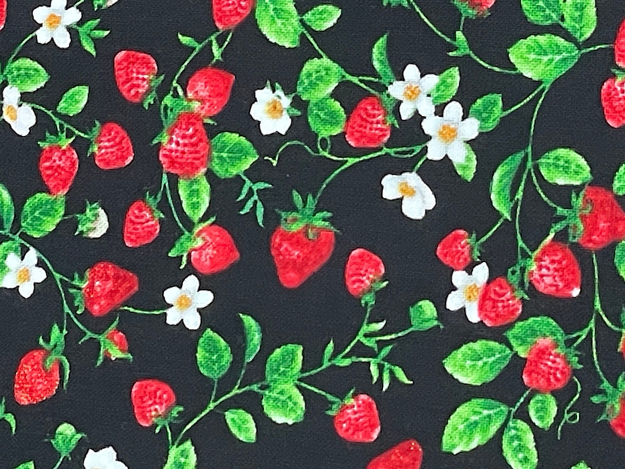 Close up of strawberries, vines and flowers.