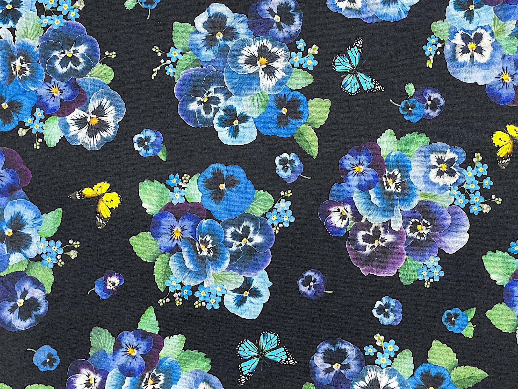 This fabric is called Pansy Bouquet and is covered with bouquets of pansies. The Pansies are shades of yellow, blue, and lavender. There are also pansy leaves and yellow butterflies. This fabric is part of the Bouquets and Butterflies Collection.