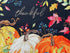 Close up of pumpkins, leaves and the word thankful.