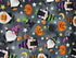 This grey cotton fabric is covered with gnomes, black cats, kettles and pumpkins. The gnomes are holding pumpkins or brooms.