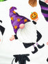 Close up of a gnome with a small pumpkin in his hand. Gnome is wearing a purple hat with orange stars.