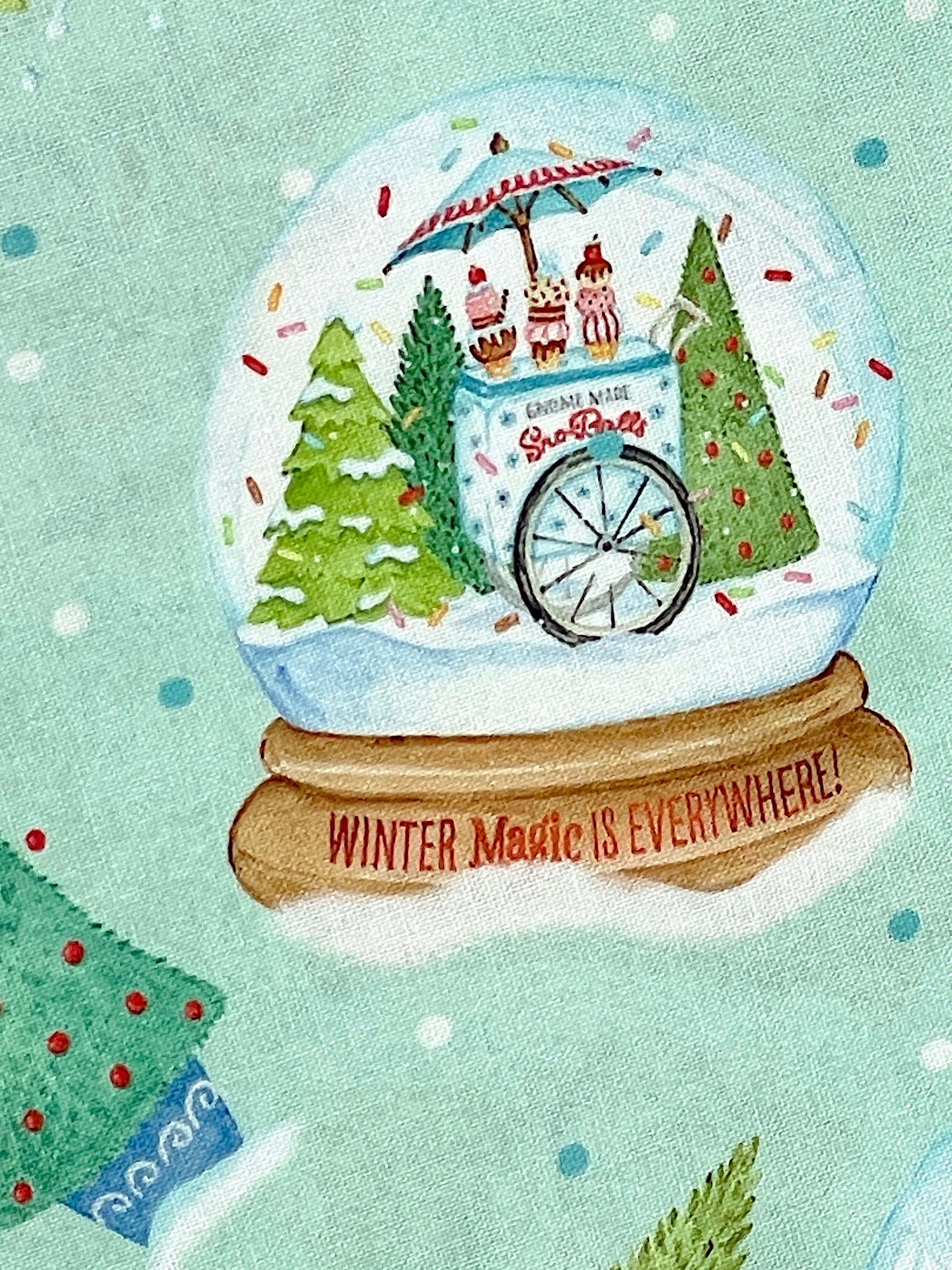 Close up of an ice cream cart and trees inside a snow globe.