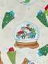 Close up of a santa gnome in a truck that is filled with trees inside of a snow globe.