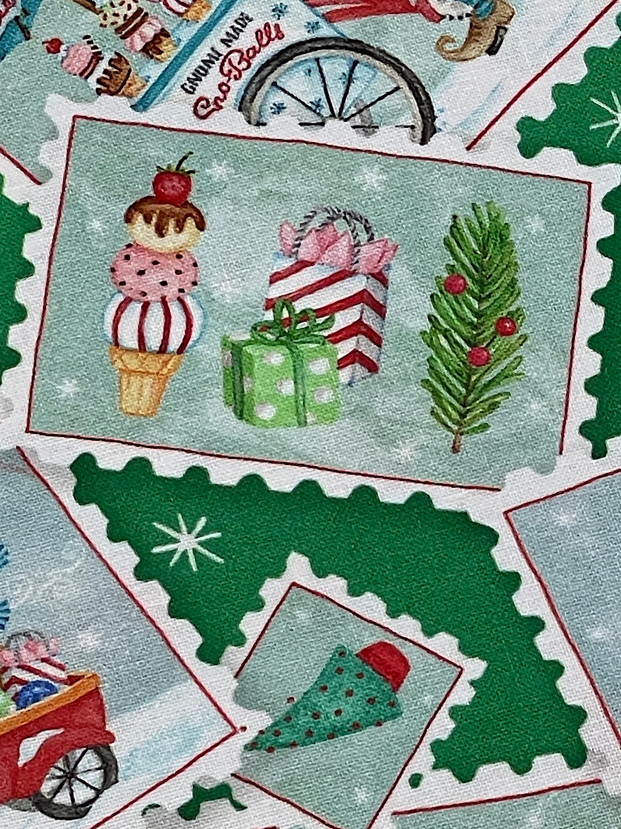 Close up of a postcard that has presents, trees and ice cream cones.