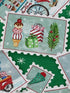 Close up of a postcard that has presents, trees and ice cream cones.
