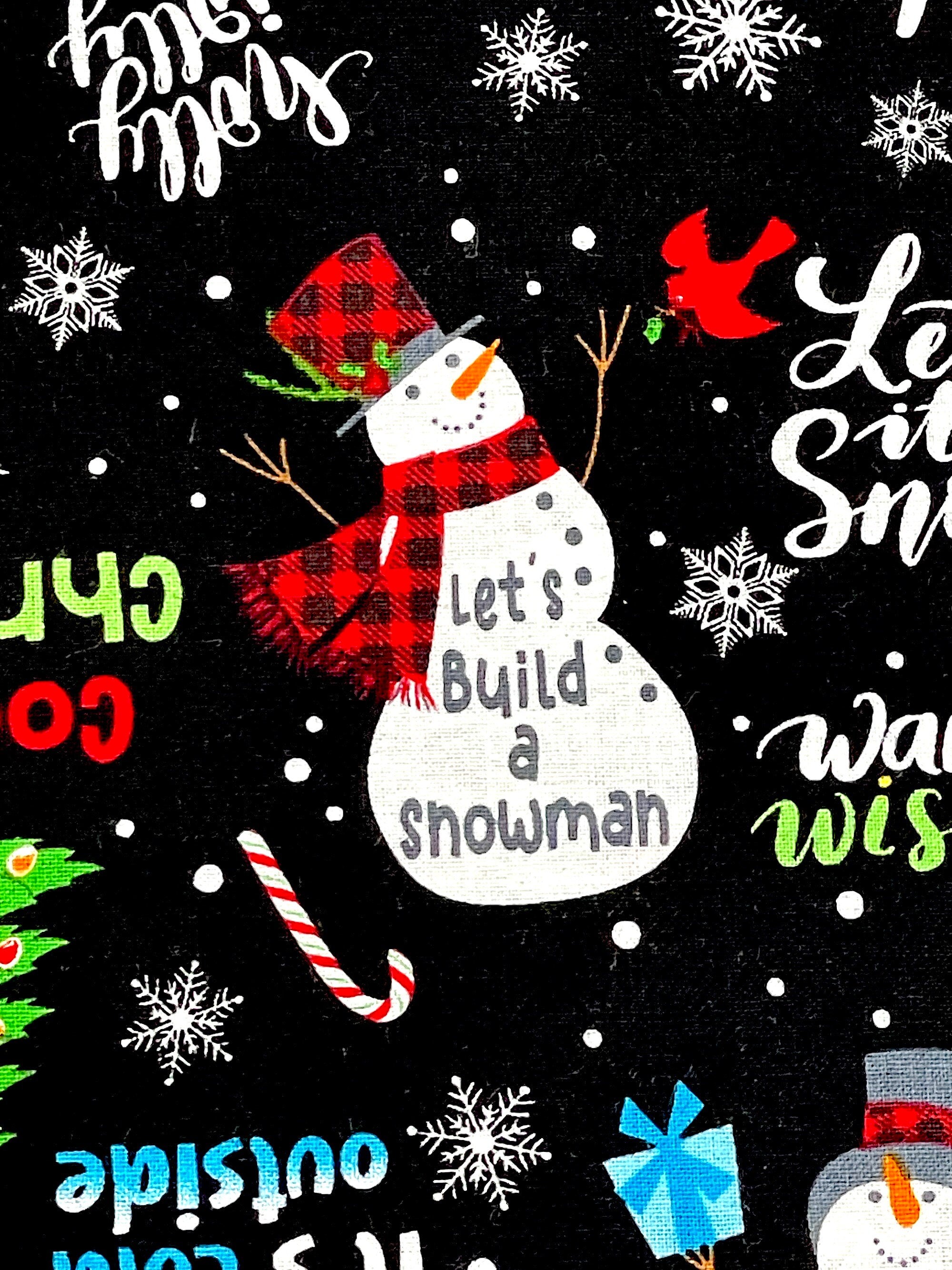 Close up of a snowman wearing a red and black hat  and scarf and the saying Let's build a snowman.