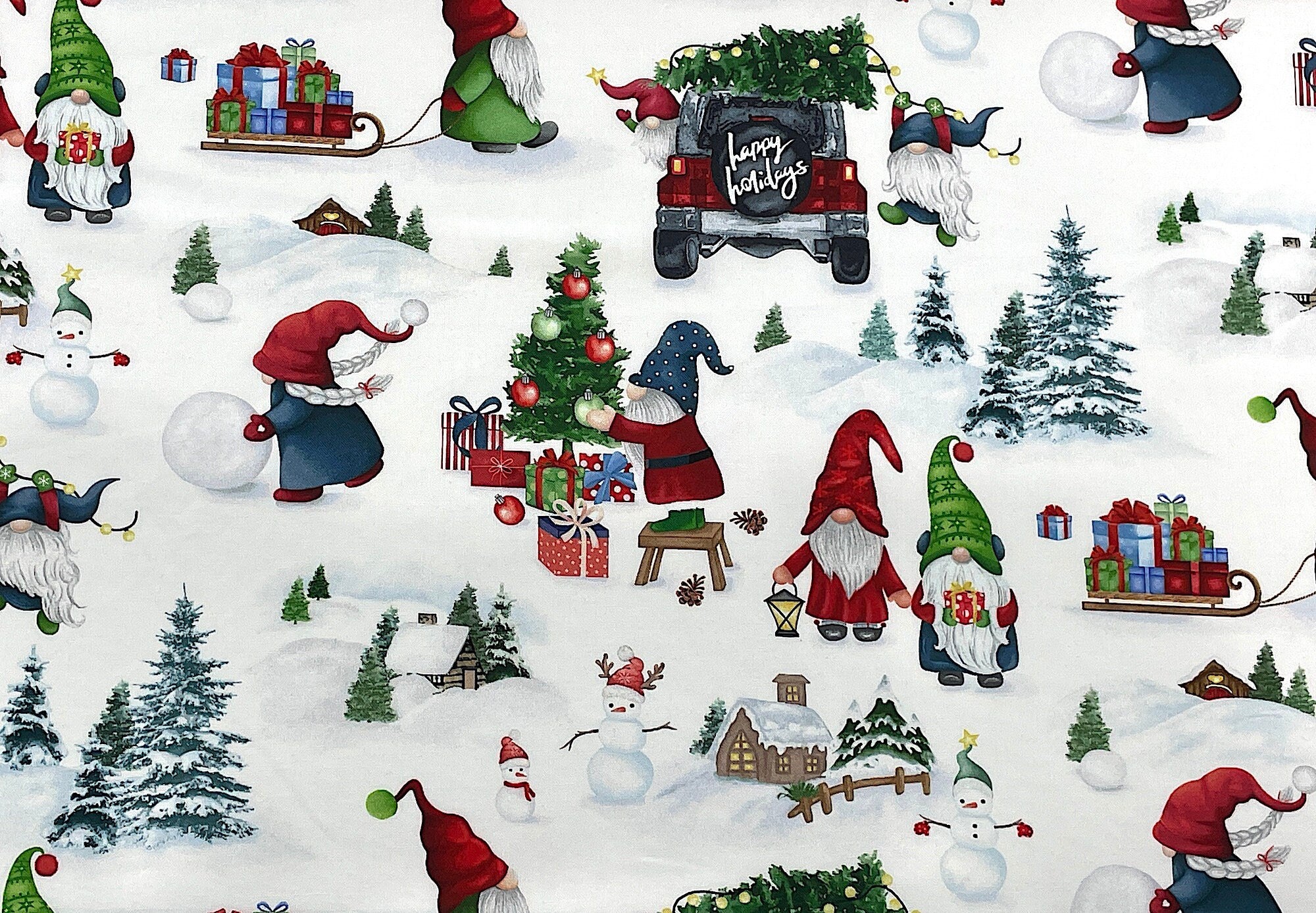 This fabric is called Gnome White Christmas Scenic. This white fabric is covered with gnomes, sleds full of presents, trees, snowmen and more.