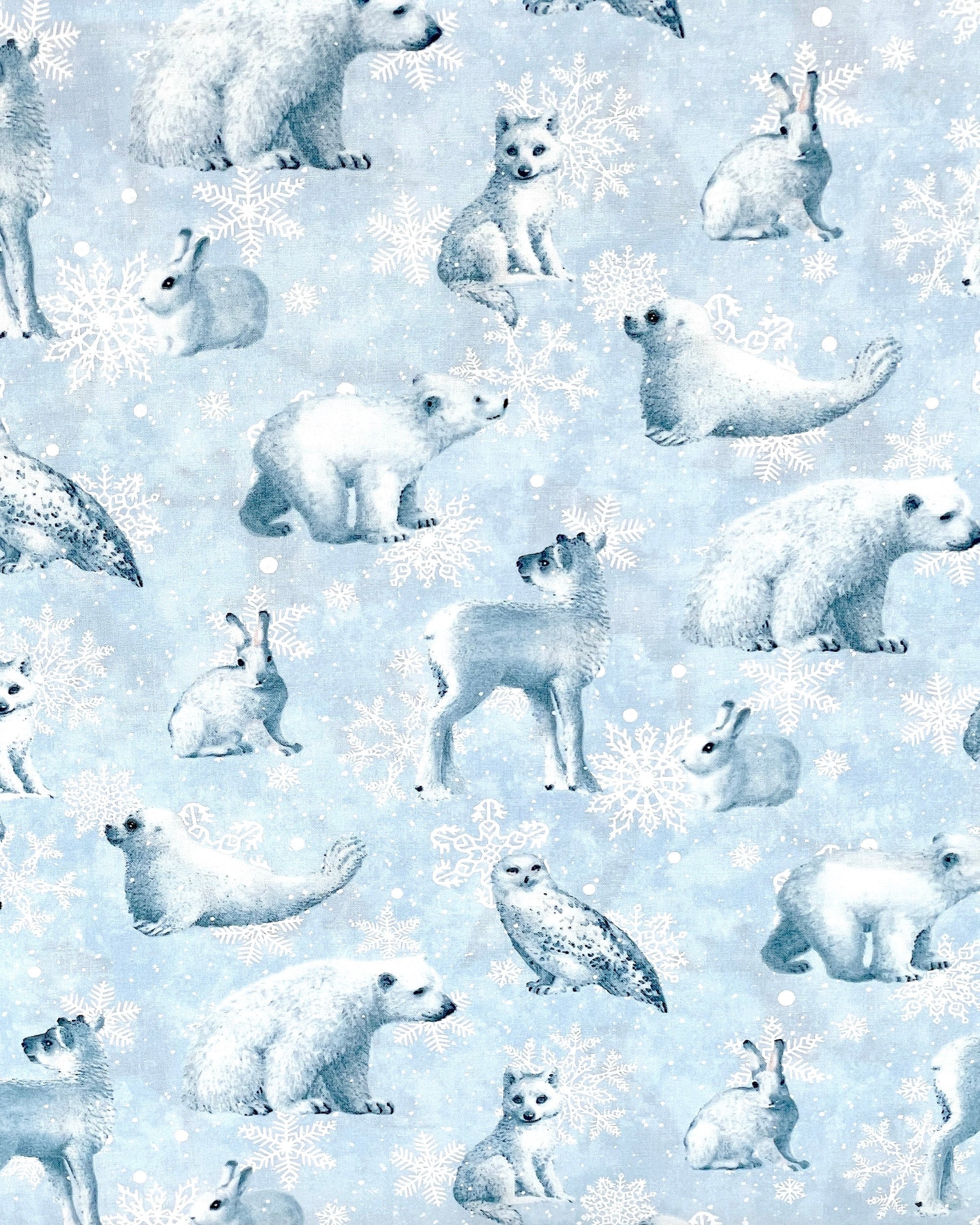 This light blue fabric is covered with bears, bunnies, seals, fox and snowflakes.