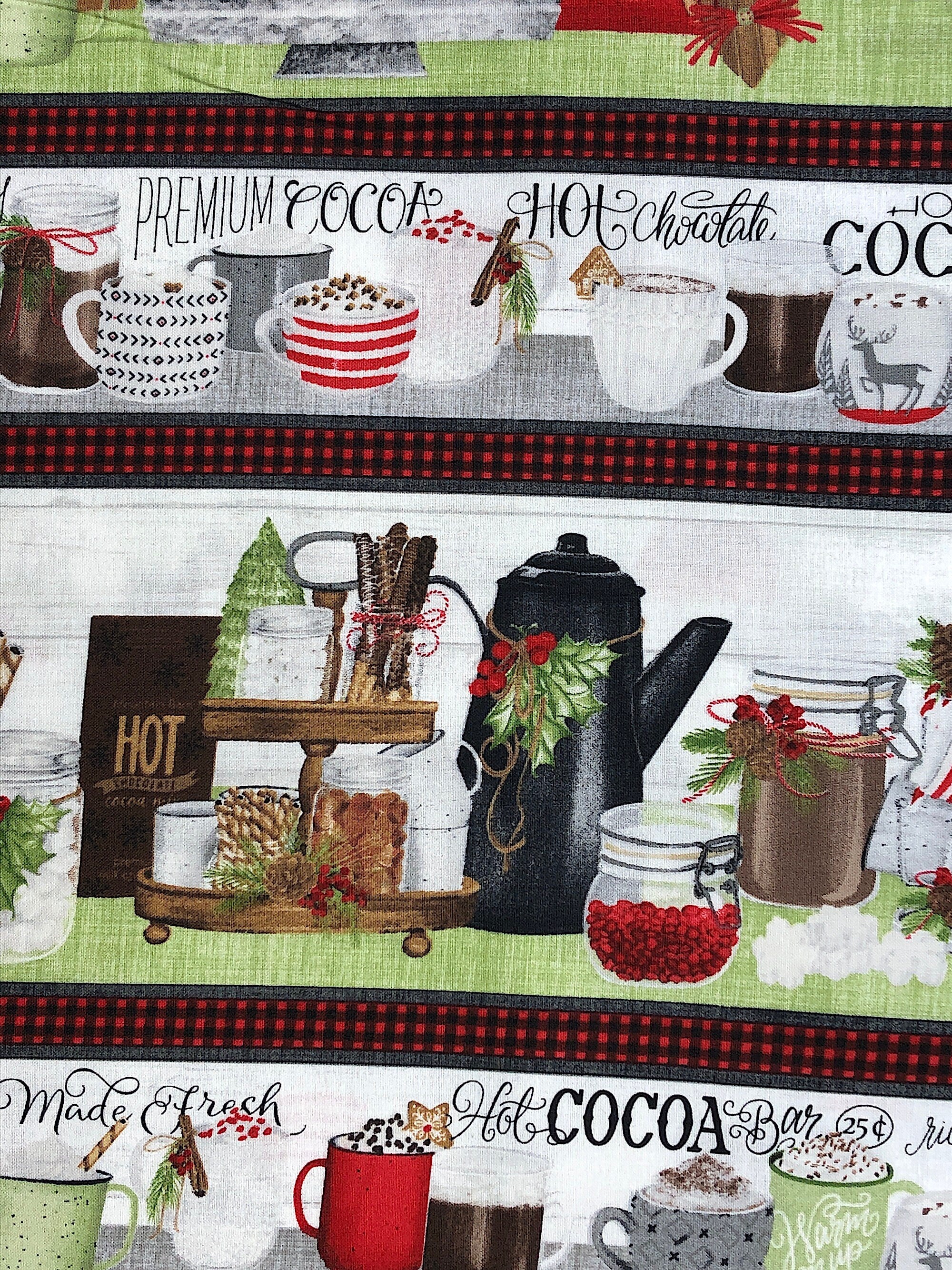 Close up of hot cocoa cups, snacks and sayings such as hot cocoa, hot chocolate and more.