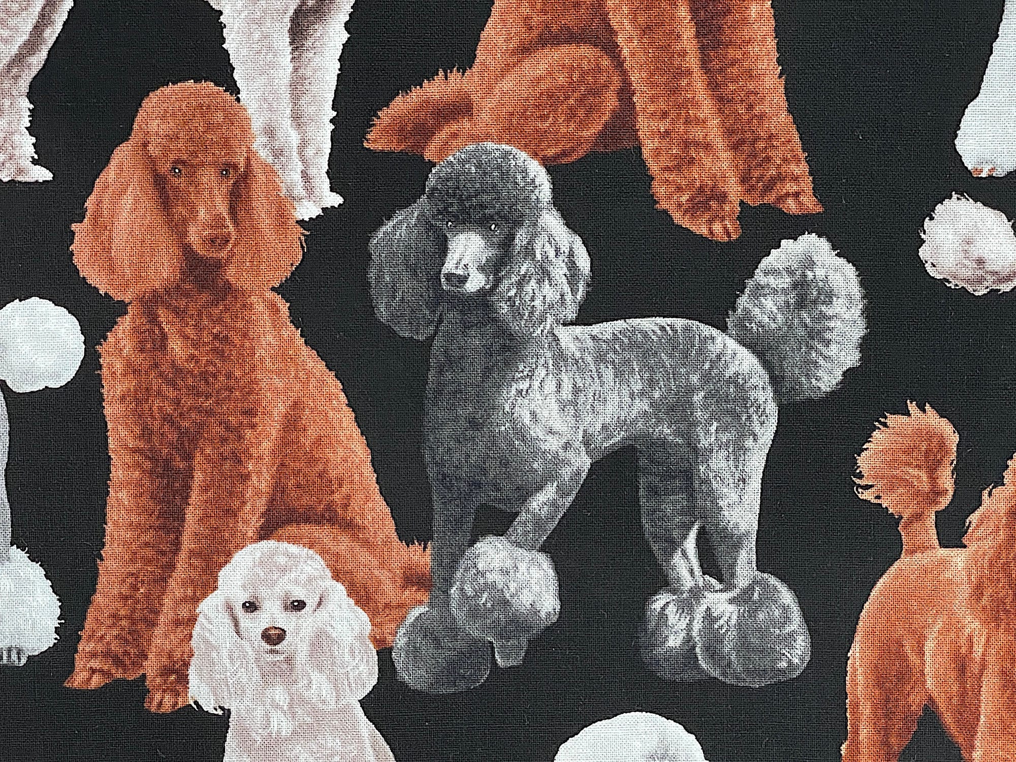 Close up of black cotton fabric with poodles on it.