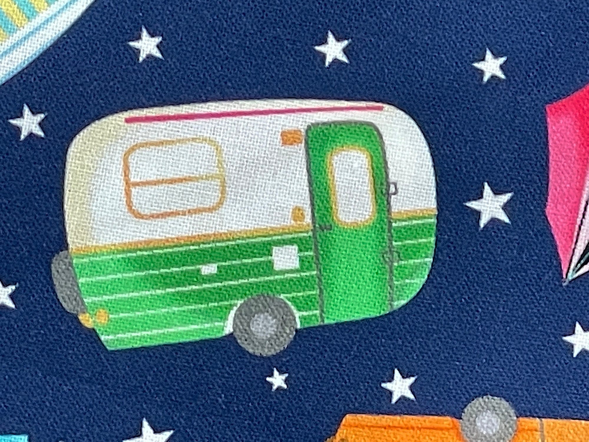 Close up of a green and white travel trailer.