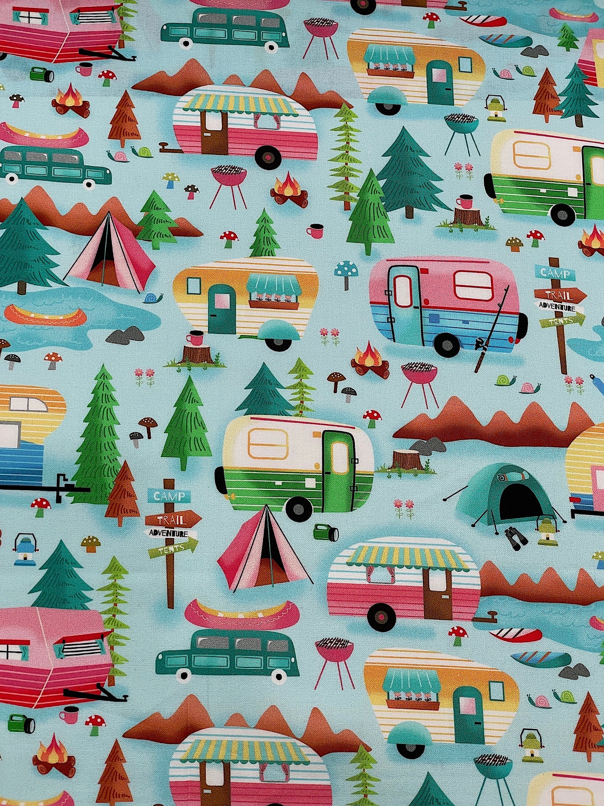 This light blue fabric is covered with a camping scene that consists of travel trailers, trees, tents, campfires, lanterns, canoes, grills, mountains and more.