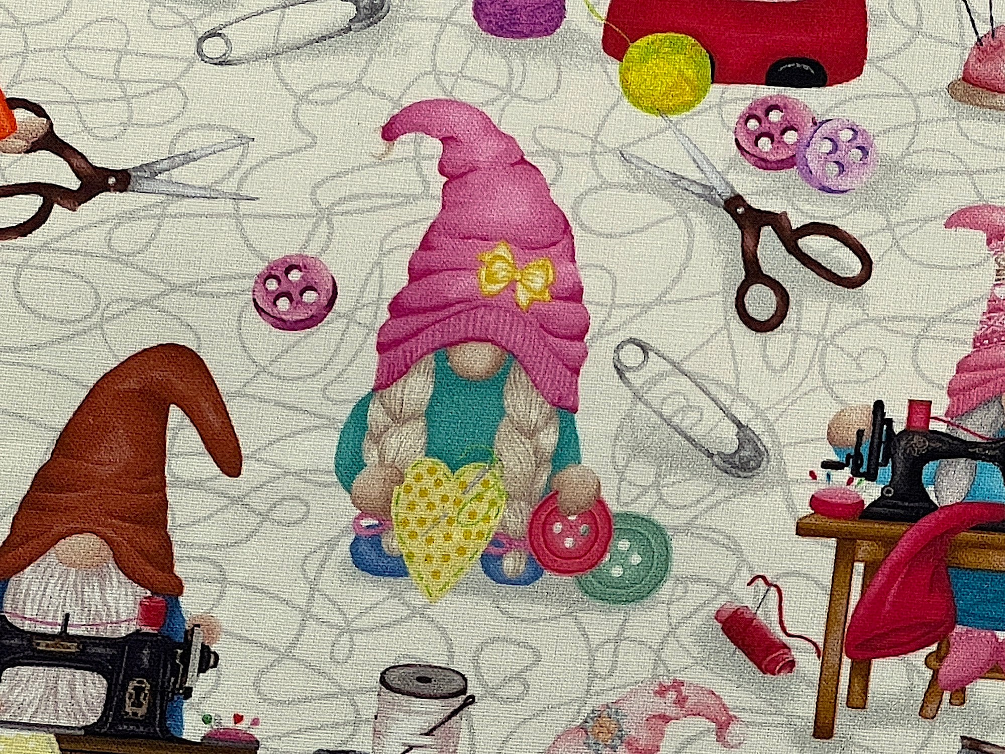 Close up of a gnome hand sewing.