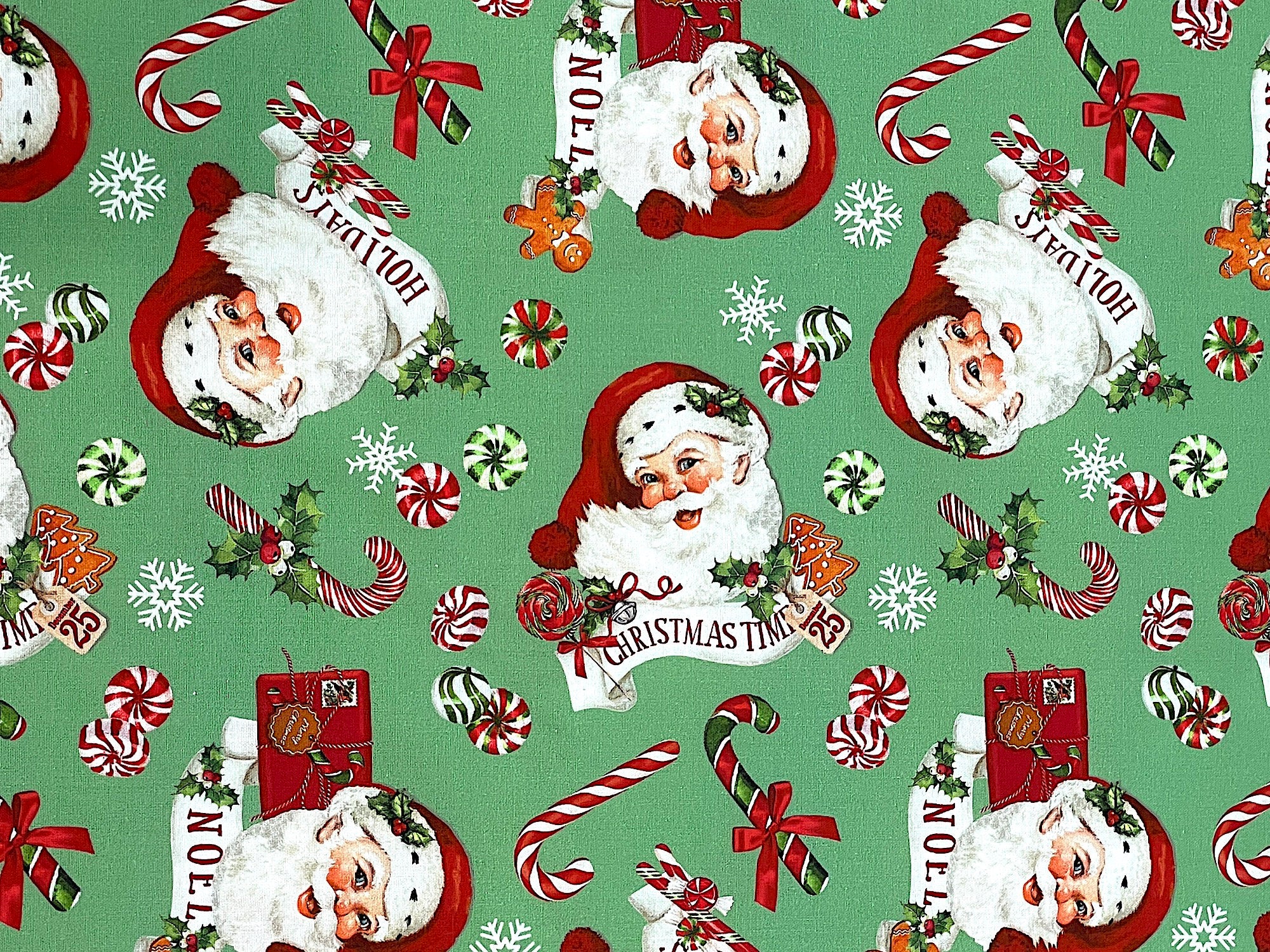 This fabric is part of the Peppermint Candy collection by Northcott Fabrics. This green fabric is covered with Santa Claus, Peppermint candy snowflakes and more