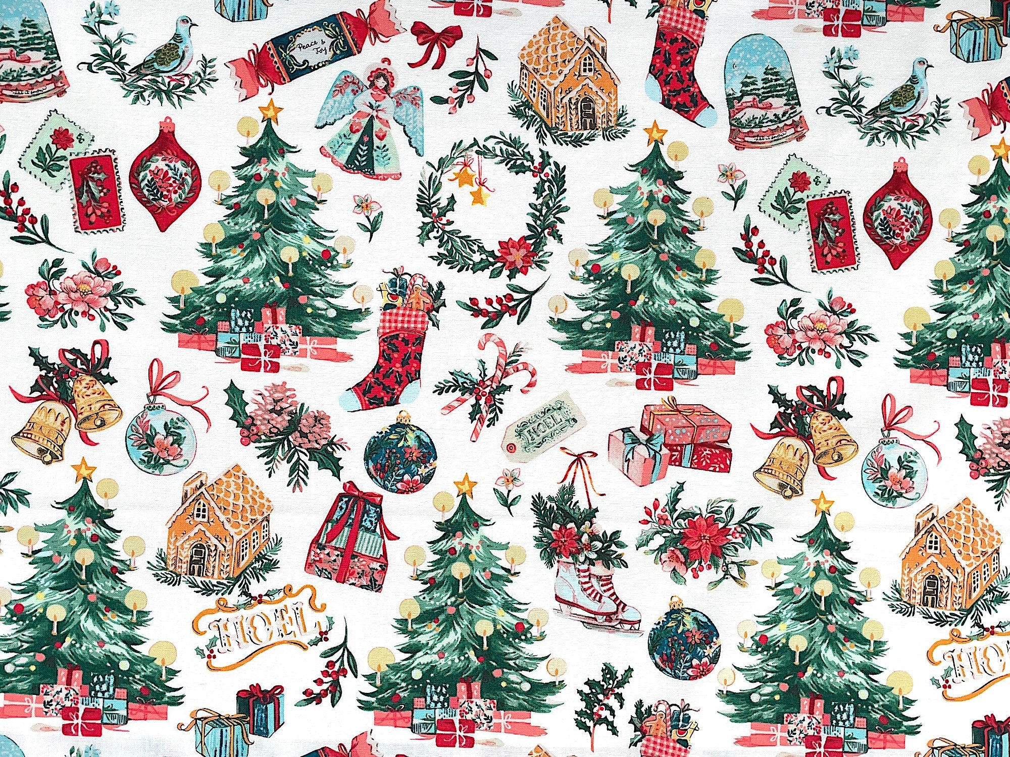 This Christmas fabric is covered with trees, angel tree toppers, stockings, candy canes, gingerbread houses, presents, bells, ornaments, gift tags and more. This fabric is called White Christmas Morning.