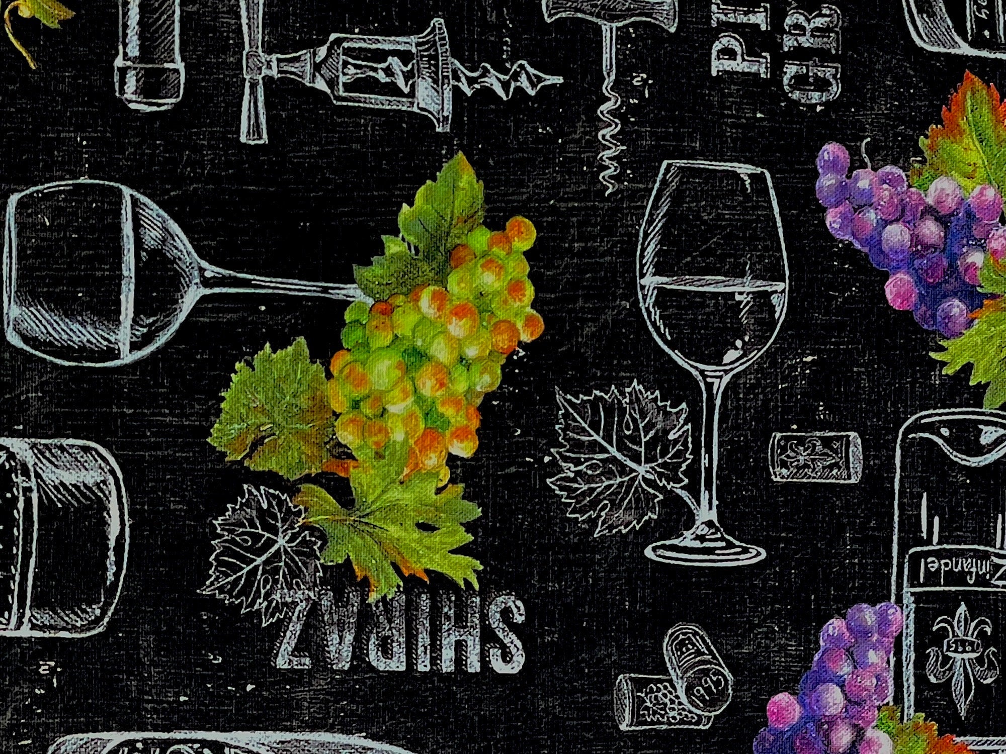 Close up of green grapes and glasses of wine.
