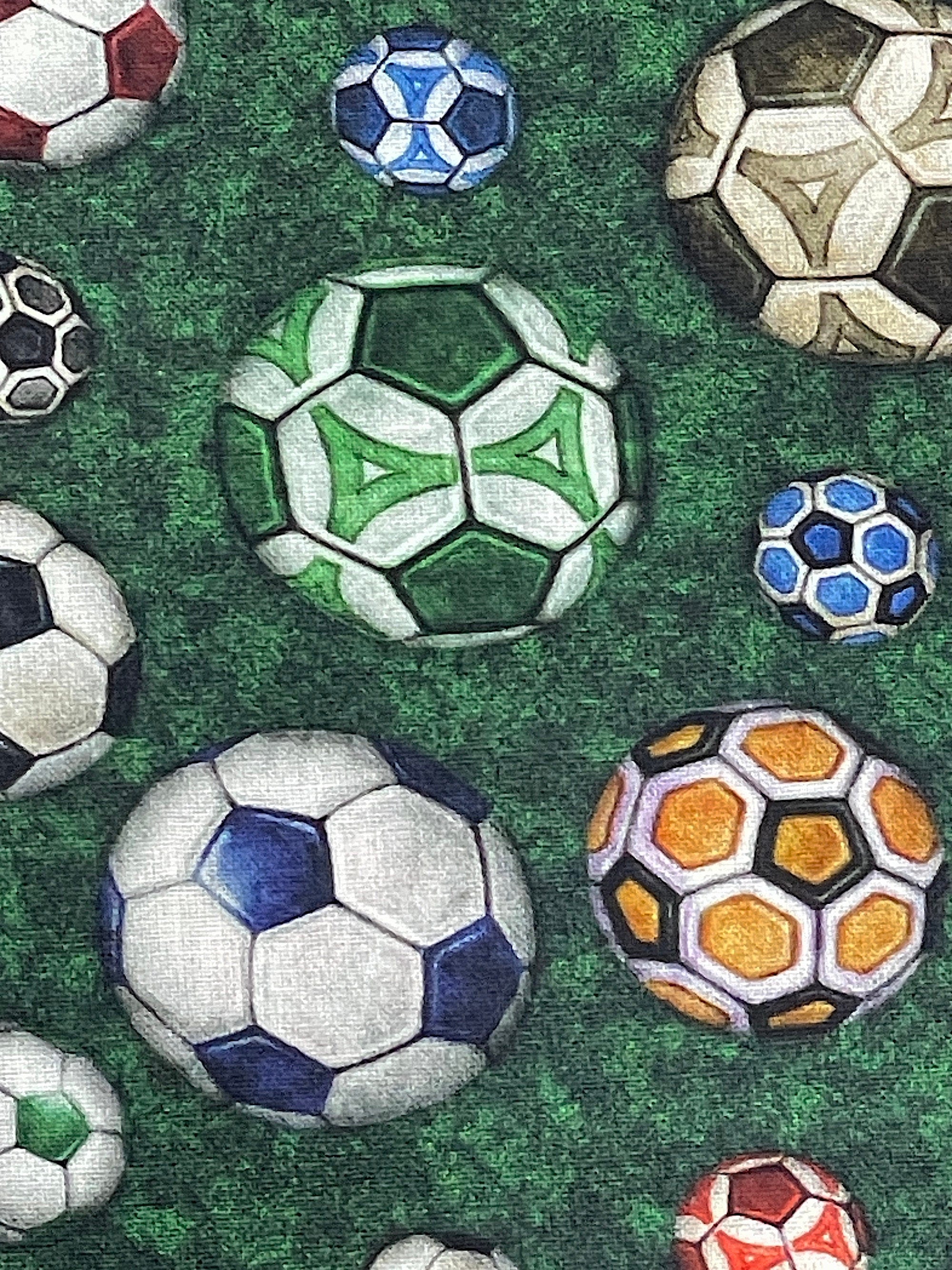 Close up of green, yellow, blue and white soccer balls.