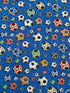 This blue cotton fabric is covered with soccer balls. The soccer balls are blue, red, yellow, orange, white and black. This fabric is part of the Just For Kicks collection by QT Fabrics.