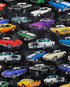This black cotton fabric is covered with old cars. The cars are white, green, blue, purple, blue, orange and black.
