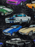 Close up of black cotton fabric covered with white, blue and black cars.