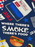 Close up of a cooler and the  saying where there's smoke there's food.