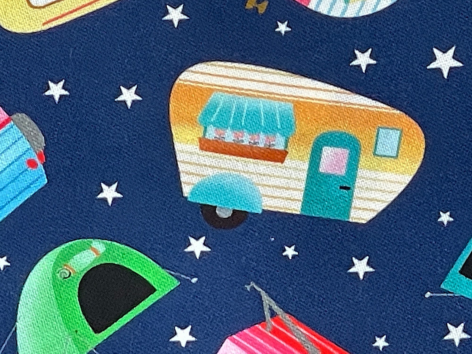 Close up of a blue, yellow and white travel trailer.