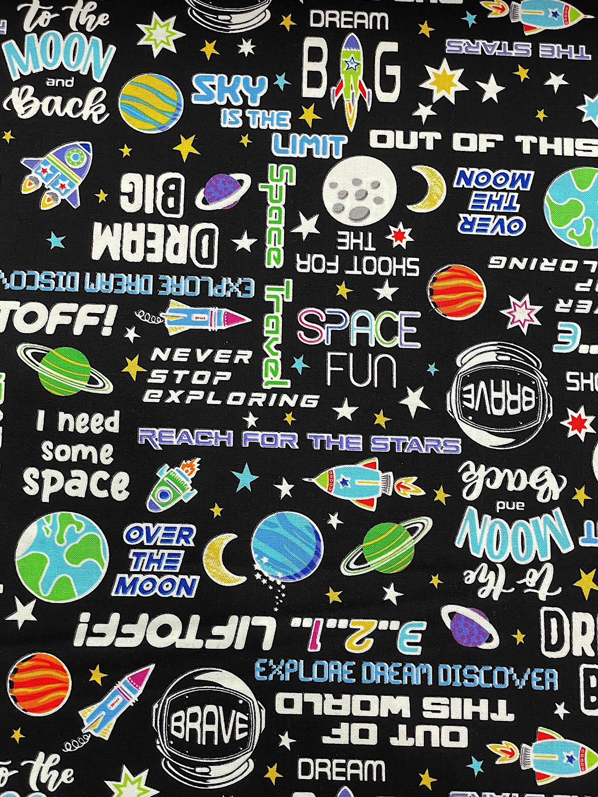 This fabric is part of the Lift Off collection by Kanvas Studio. This black fabric is covered with moons, and sayings such as to the moon and back, out of this world, dream big, lift off, sky is the limit and more.