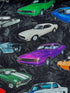 Black cotton fabric covered with green, white and purple cars.