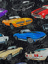 Close up of black cotton fabric covered with cars.