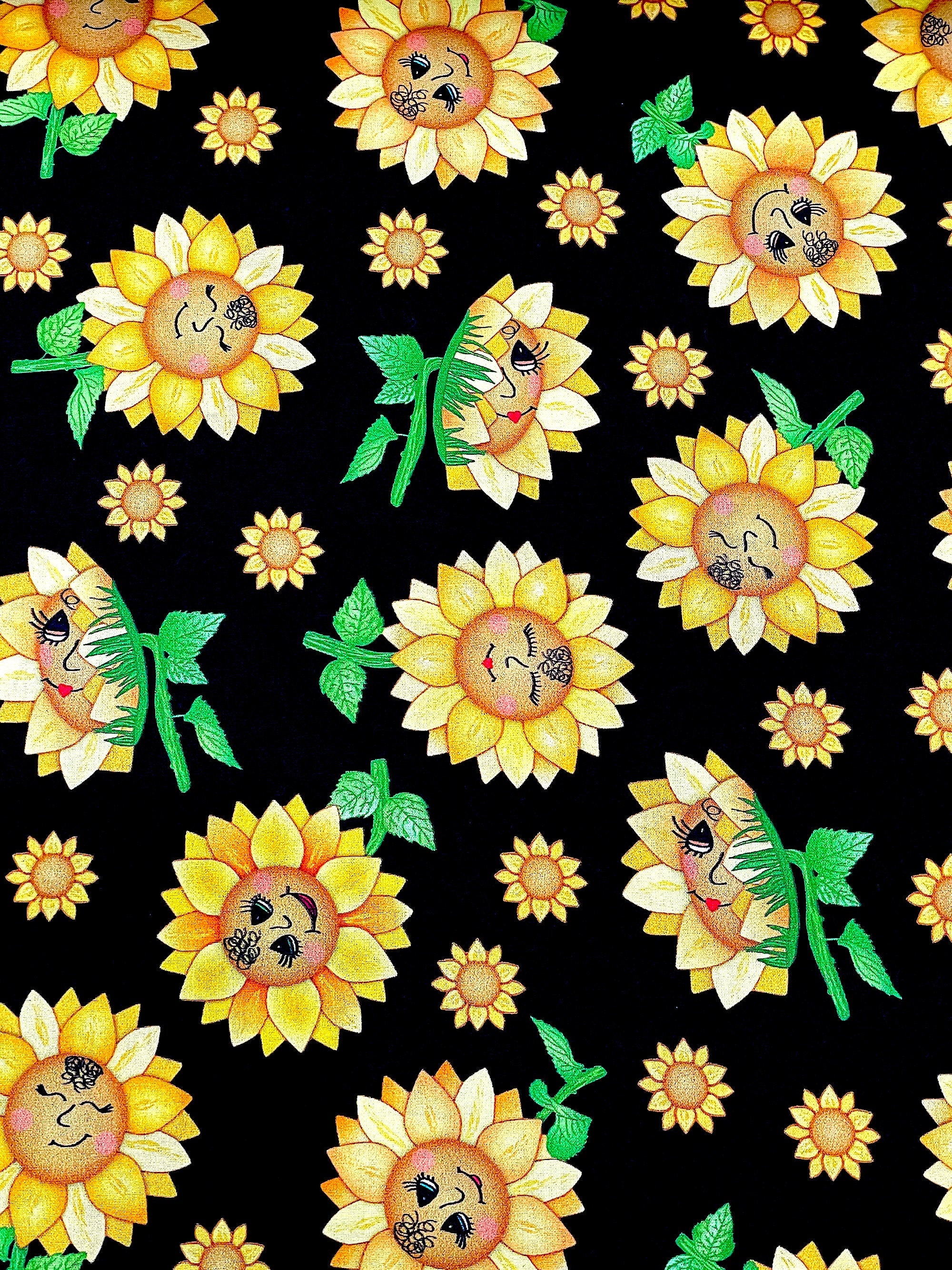 This black cotton fabric is covered with sunflowers with faces. This fabric is called Funflowers.