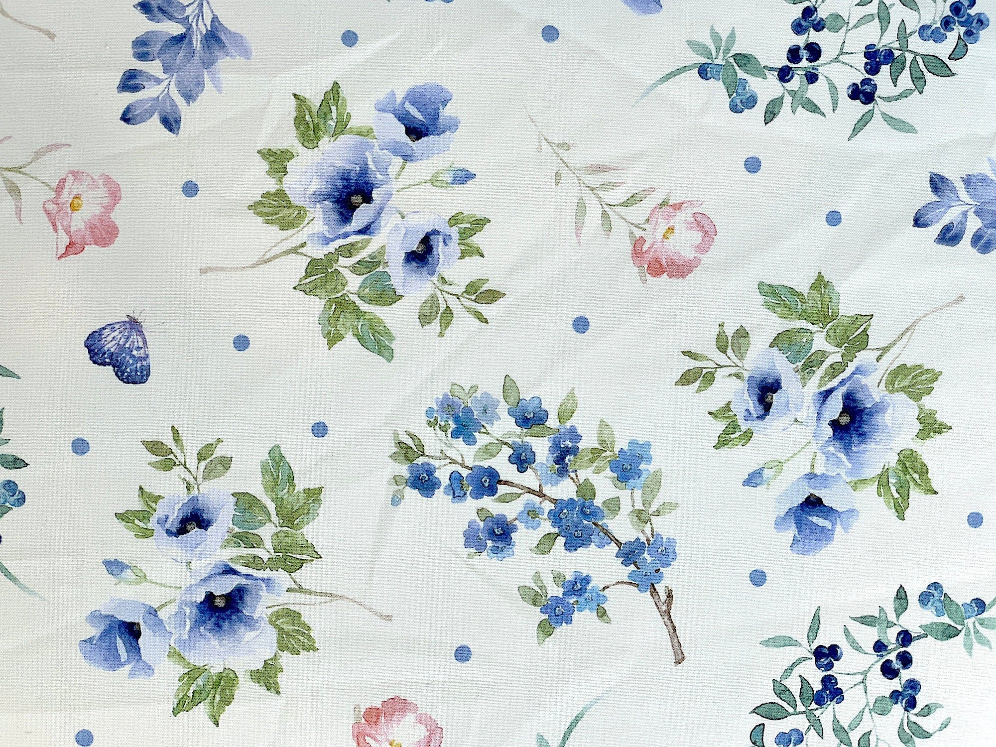 This fabric is part of the Indigo Petals collection by Beth Grove. This white fabric is covered with blue and pink flowers, green leaves and blue butterflies. See my other listings for this design on blue.