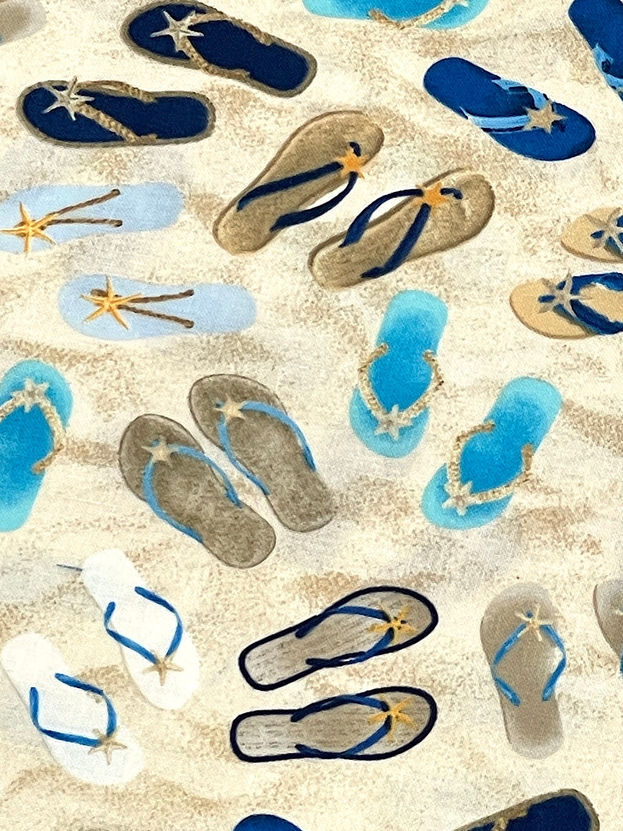 Close up of flip flops on the sand.